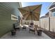 Outdoor patio with lounge seating, black and white rug, and large umbrella at 5037 N Quemoy St, Aurora, CO 80019