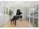 Elegant room featuring a grand piano, hardwood floors, and ample natural light at 5037 N Quemoy St, Aurora, CO 80019