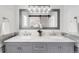 Elegant bathroom with double sinks, marble countertops, and modern lighting at 10015 Apollo Bay Way, Highlands Ranch, CO 80130