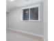 Finished basement featuring neutral walls, white trim, and a bright window at 434 Clayton St, Denver, CO 80206