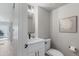 Modern half-bathroom with a white vanity, black fixtures, and stylish decor at 434 Clayton St, Denver, CO 80206
