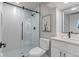 Modern bathroom featuring a glass enclosed shower, white vanity, and stylish fixtures at 434 Clayton St, Denver, CO 80206