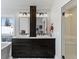 Bright bathroom featuring a double vanity, tub, and window with a view of the winter snow at 434 Clayton St, Denver, CO 80206