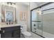 Modern bathroom with glass-enclosed shower and dark vanity for a sleek, contemporary look at 434 Clayton St, Denver, CO 80206