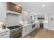 Well-equipped kitchen with stainless steel appliances, white cabinetry, and hardwood floors at 434 Clayton St, Denver, CO 80206