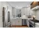 Bright modern kitchen features stainless steel appliances, white cabinets, and ample counter space at 434 Clayton St, Denver, CO 80206