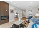 Cozy living room with a fireplace, modern decor, and an open view to the kitchen and dining area at 434 Clayton St, Denver, CO 80206
