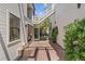 Charming patio area with brick pavers, lush greenery, and an outdoor staircase at 434 Clayton St, Denver, CO 80206