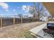 Wide backyard featuring a lawn, a wood fence, and a patio area with outdoor seating and a grill at 2738 S Newton St, Denver, CO 80236