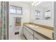 Bathroom featuring an extended vanity countertop with ample cabinet storage below the sink at 2738 S Newton St, Denver, CO 80236