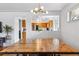 Dining room features a rustic table and modern lighting with a view into the kitchen at 2738 S Newton St, Denver, CO 80236