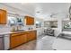 Bright and open kitchen with wood cabinets, stainless steel sink, and tile floors at 2738 S Newton St, Denver, CO 80236