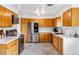 Spacious kitchen equipped with wood cabinets, stainless steel appliances, and ample counter space at 2738 S Newton St, Denver, CO 80236