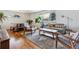 Bright living room featuring hardwood floors, a patterned rug, and lots of natural light at 2738 S Newton St, Denver, CO 80236