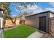 Private backyard with a stone patio, grassy area, and dark siding at 2930 W 34Th Ave, Denver, CO 80211