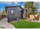 Cozy backyard with a stone patio, grassy area, and dark siding at 2930 W 34Th Ave, Denver, CO 80211