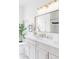 Bright bathroom featuring double vanity, sink, elegant lighting, and a shower behind a glass wall at 2930 W 34Th Ave, Denver, CO 80211