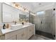 Bathroom featuring double vanity, vessel sinks, elegant lighting, and glass enclosed shower with grey tiling at 2930 W 34Th Ave, Denver, CO 80211