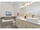 Bathroom with a tub, toilet, double vanity, vessel sinks, and grey tile halfway up the wall at 2930 W 34Th Ave, Denver, CO 80211