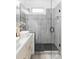 Bright bathroom with white vanity, modern vessel sink, and a glass-enclosed shower with gray tile at 2930 W 34Th Ave, Denver, CO 80211