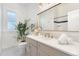 Bright bathroom with a double vanity, sink, an elegant mirror, and a shower behind a glass wall at 2930 W 34Th Ave, Denver, CO 80211