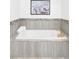 Cozy bathtub with white tile, a stylish gold faucet and fixtures, and neutral wall tiling at 2930 W 34Th Ave, Denver, CO 80211