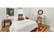 Bright bedroom featuring neutral colors, a decorative rug, and a seating area at 2930 W 34Th Ave, Denver, CO 80211