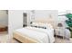 Comfortable bedroom showcasing a bed with many pillows and a neutral color palette at 2930 W 34Th Ave, Denver, CO 80211