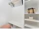 Bright closet featuring built-in shelving, a wooden rod, and a comfortable sitting area at 2930 W 34Th Ave, Denver, CO 80211