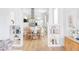 Open dining area features a round table, wood floors, and adjacent kitchen at 2930 W 34Th Ave, Denver, CO 80211