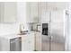 Bright kitchen featuring white cabinetry, stainless steel appliances, and a modern sink with gold fixtures at 2930 W 34Th Ave, Denver, CO 80211