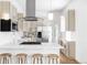 Modern kitchen boasts stainless appliances, white countertops, and bar seating at 2930 W 34Th Ave, Denver, CO 80211