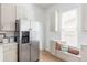 Bright kitchen with stainless steel refrigerator, built-in window seating, and decorative pillows at 2930 W 34Th Ave, Denver, CO 80211