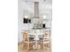 Modern eat-in kitchen with stainless steel appliances and custom hood at 2930 W 34Th Ave, Denver, CO 80211