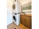 Convenient laundry area featuring stacked washer and dryer and storage cabinet at 2930 W 34Th Ave, Denver, CO 80211