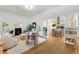 Bright, stylish living room with hardwood floors, fireplace, and adjacent kitchen at 2930 W 34Th Ave, Denver, CO 80211