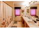 Bathroom with double sinks, tub, shower, and medicine cabinet at 17085 E Dorado Cir, Centennial, CO 80015