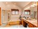Bright bathroom featuring dual sinks, a separate shower, and a bathtub set beneath a window at 17085 E Dorado Cir, Centennial, CO 80015