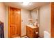 Basement bathroom featuring a wood vanity, mirror, and toilet at 17085 E Dorado Cir, Centennial, CO 80015