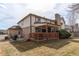 Exterior view of the home showcasing a deck, brick accents, and a well-kept lawn at 17085 E Dorado Cir, Centennial, CO 80015