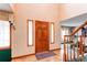 Bright and airy foyer with hardwood floors and a wooden front door at 17085 E Dorado Cir, Centennial, CO 80015