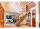 Elegant foyer with a curved staircase, hardwood floors, and chandelier at 17085 E Dorado Cir, Centennial, CO 80015