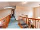 Upstairs hallway featuring wood railings, wall-to-wall carpet, and a skylight for natural light at 17085 E Dorado Cir, Centennial, CO 80015