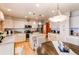 Bright kitchen features island with seating, stainless appliances and updated countertops at 17085 E Dorado Cir, Centennial, CO 80015