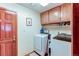 A well-lit laundry room featuring a washer, dryer, upper cabinets, and a laundry sink at 17085 E Dorado Cir, Centennial, CO 80015