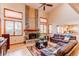 Bright living room with brick fireplace, hardwood floors and comfortable leather seating at 17085 E Dorado Cir, Centennial, CO 80015