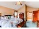 Bright main bedroom featuring a vaulted ceiling, floral bedding, and an ensuite bathroom with walk in closet at 17085 E Dorado Cir, Centennial, CO 80015
