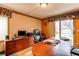This is a warm office space with built-in wooden cabinetry and a door leading to the backyard at 17085 E Dorado Cir, Centennial, CO 80015