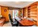 Home office with built-in bookshelves and sliding glass door at 17085 E Dorado Cir, Centennial, CO 80015