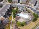 Aerial view of community pool and clubhouse with surrounding landscaping and nearby townhomes at 11230 Osage Cir # B, Northglenn, CO 80234